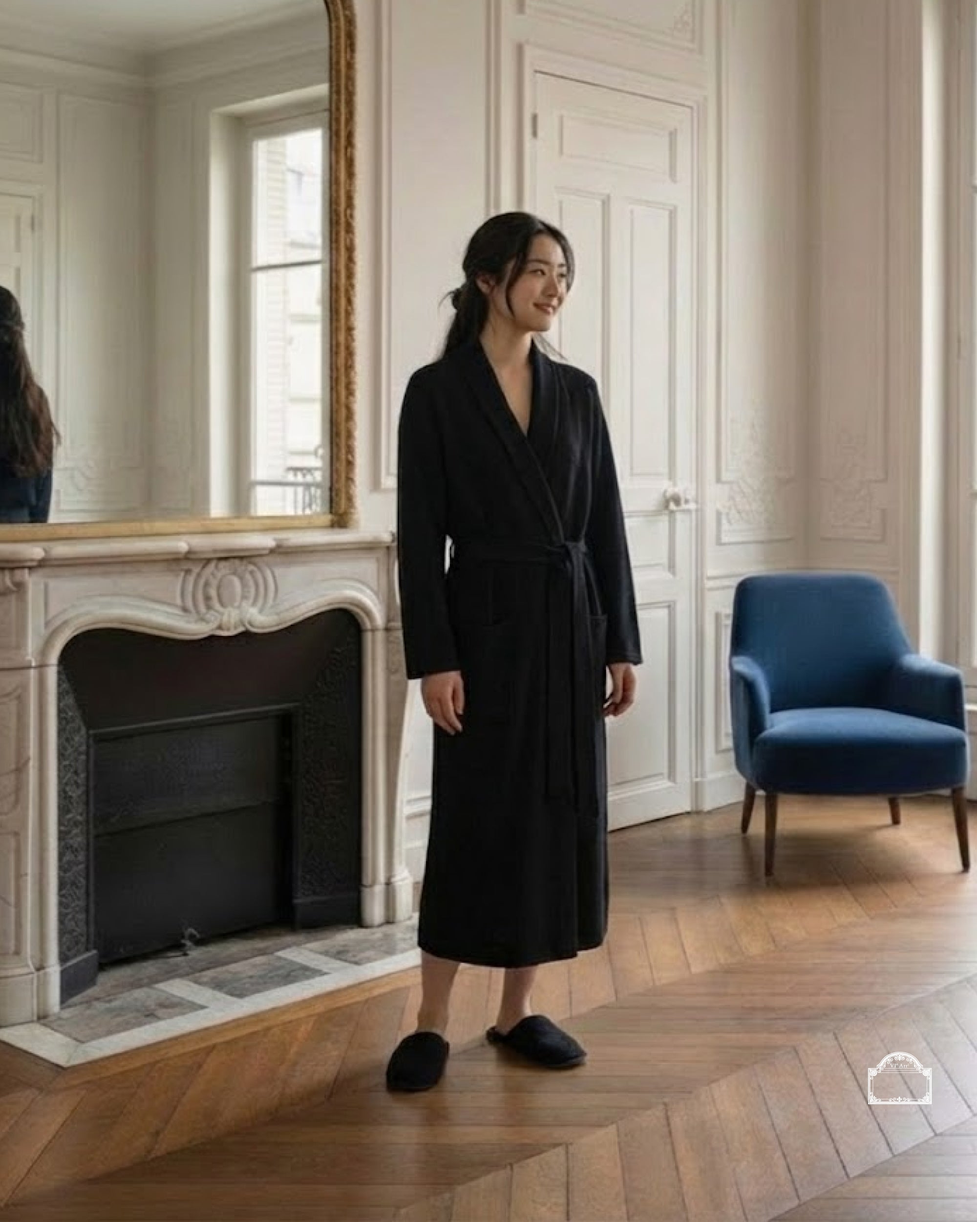 Model wearing a black cachemire bathrobe in an elegant interior with natural light.