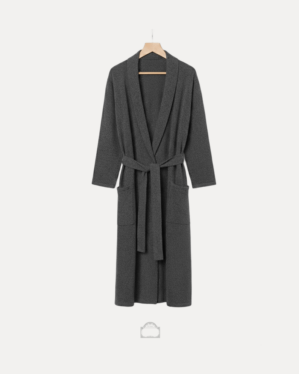 Grey cachemire bathrobe hanging with a tie belt, showcasing elegance and comfort in luxurious fabric.