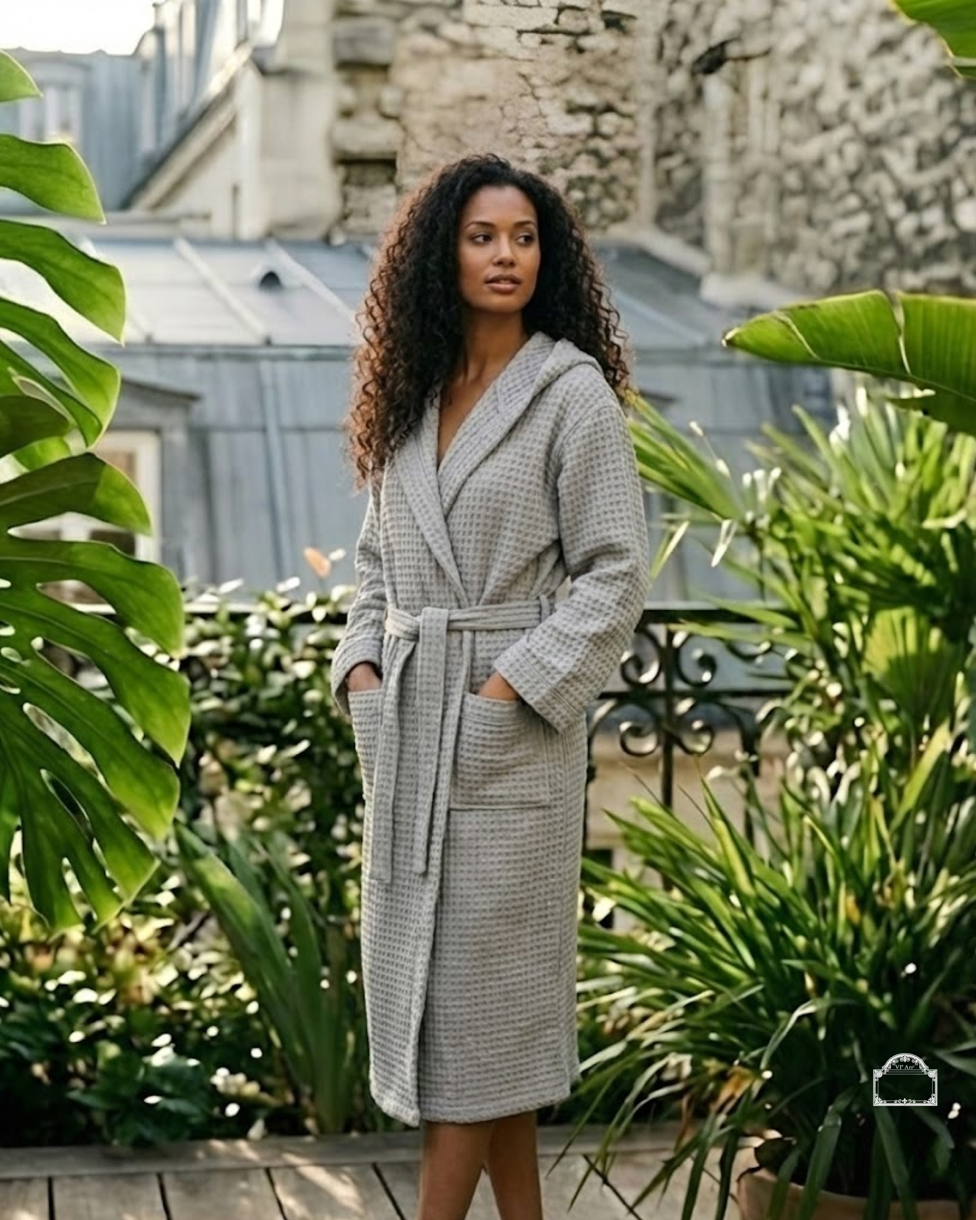 Woman wearing grey waffle bathrobe in Parisian terrace