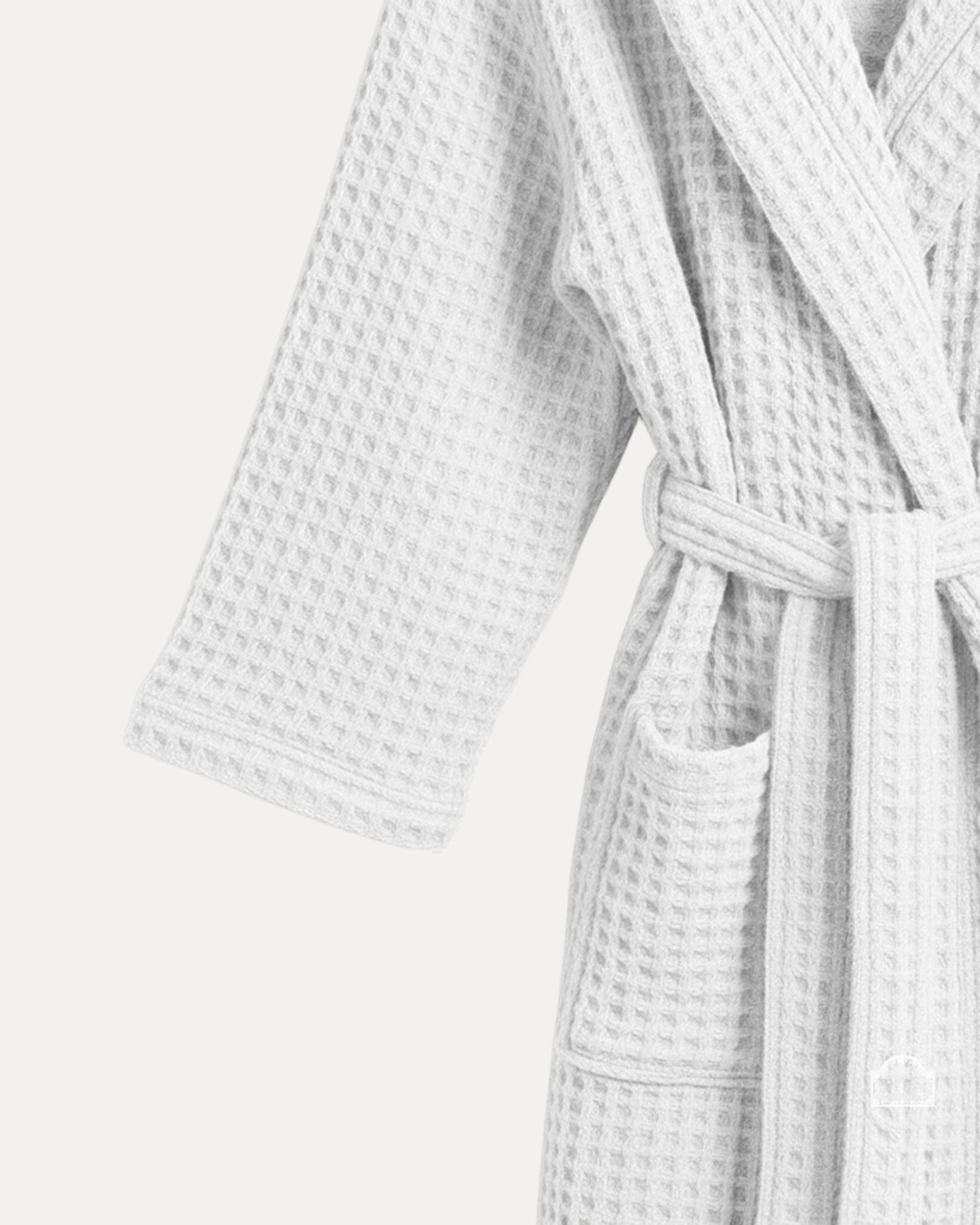 The white waffle bathrobe fabric detail with premium honeycomb weave